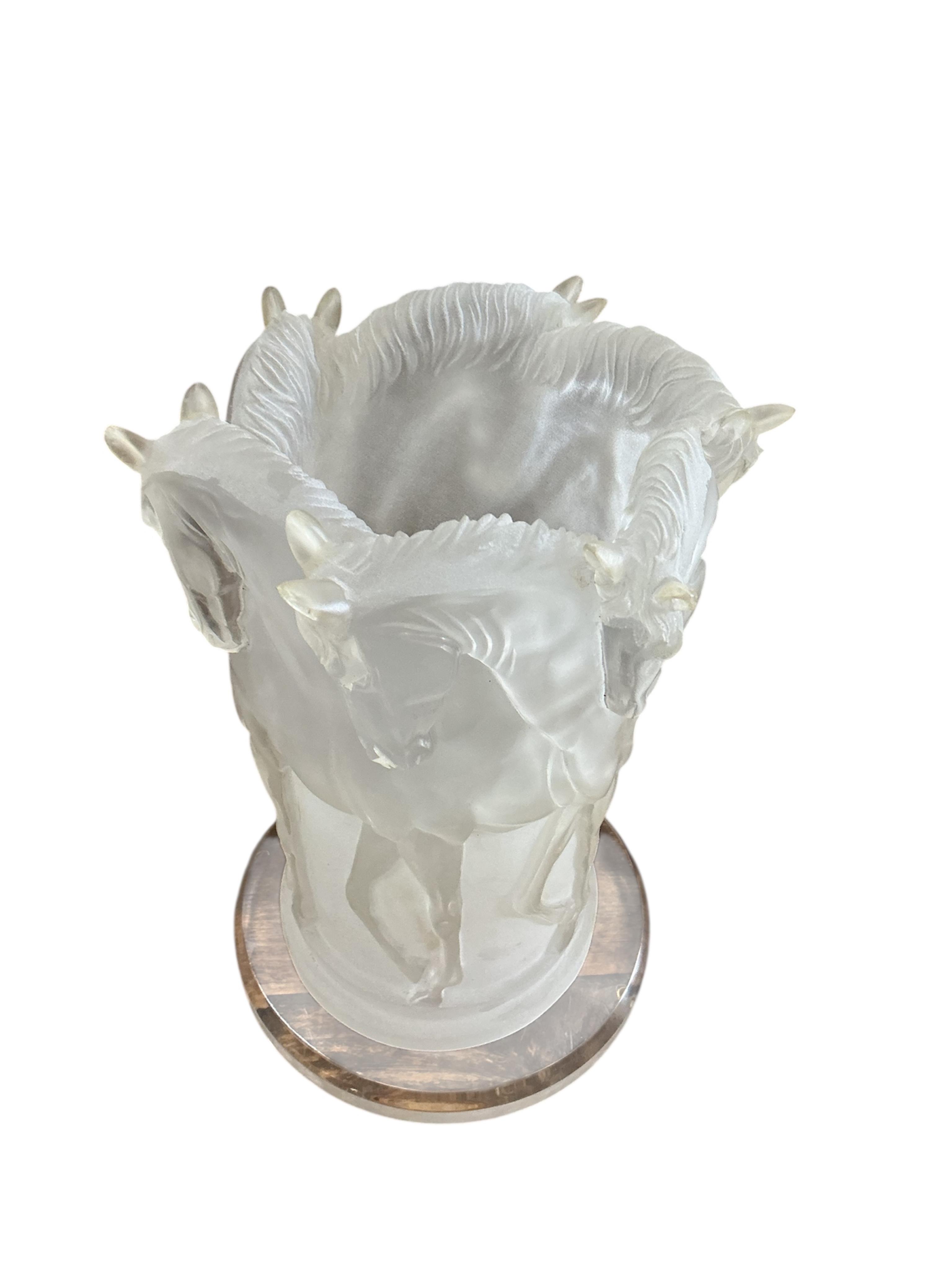 A Lucite table lamp moulded with a band of horses, 31cm high.